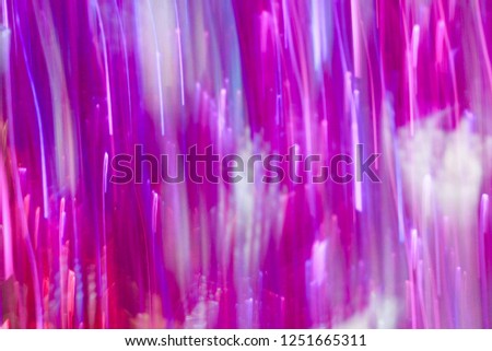 Abstract purple shining tinsel garland with low speed shutter