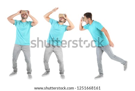 Set with man using cardboard virtual reality headset on white background