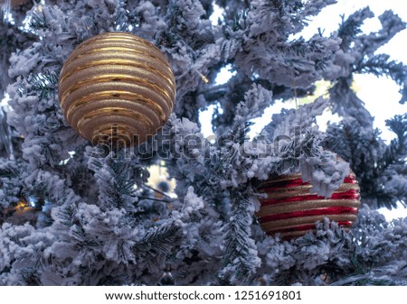 Gold and red christmas day decoration ornaments decorated on christmas tree covered with snow