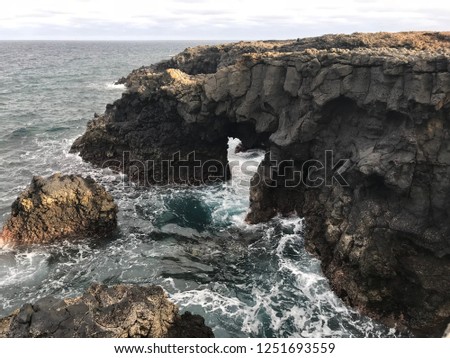 Stones arch in water surface view of the ocean in the Canarias island