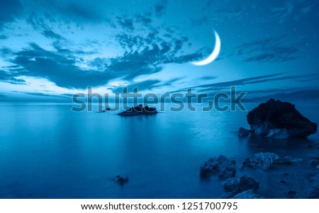 Night sky with blue moon in the clouds "Elements of this image furnished by NASA