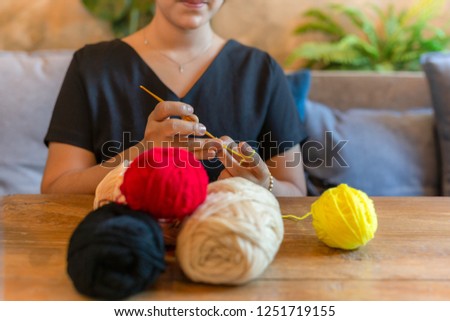 Woman hand knitting crochet at home as hobby.