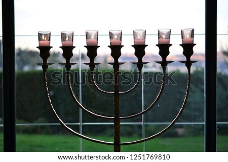 beautiful Menorah jewish 7 armed lampstand standing in window, mount zion in background JERUSALEM ISRAEL