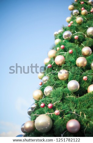 Beautiful decorated christmas tree. Chrismas tree background on blue sky