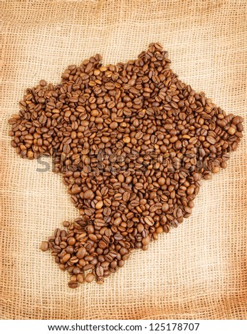 Brazilian map made out of coffee beans on jute background