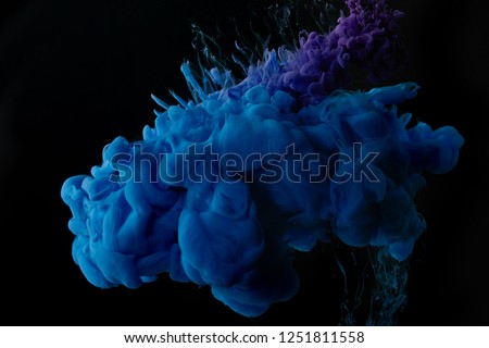 dark background with abstract blue swirls of paint
