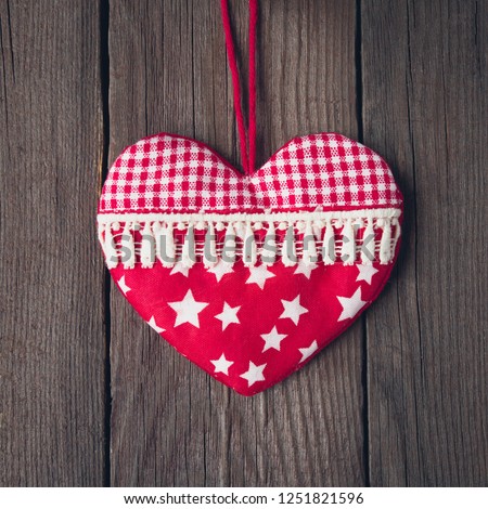 Old toy heart on a wooden background. Valentine's Day card