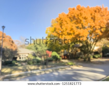Motion blurred facade entrance of typical single-family home with attached garage near Dallas, Texas, USA in fall season