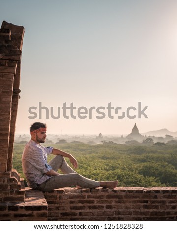 young man traveler at an old temple inm Bagan Myanmar, men and woman at old Pagoda in Bagan Pagan Myanmar Burma