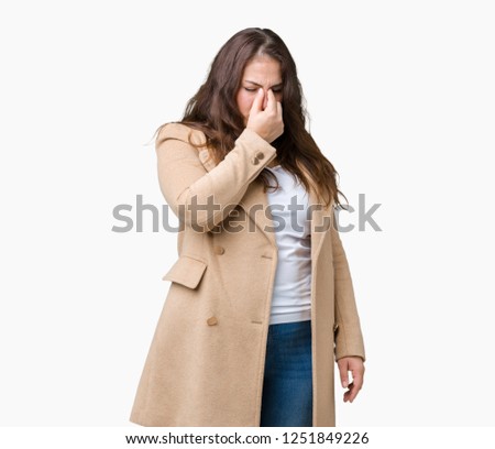 Beautiful plus size young woman wearing winter coat over isolated background tired rubbing nose and eyes feeling fatigue and headache. Stress and frustration concept.