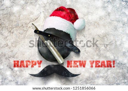Razor on a plate for foam with a Santa Claus hat on a gray background. Inscription Happy New Year. Greeting card Happy New Year and Merry Christmas for a hairdresser and barber shop. Snow Effect