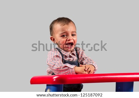 Picture of a child crying in the nursery in gray