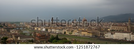 Aerial view of the Ponte Vecchio bridge in Florence, Italya, under a cloudy sky in Spring.