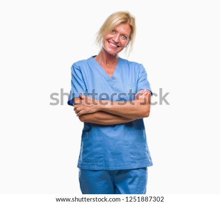 Middle age blonde woman wearing doctor nurse uniform over isolated background happy face smiling with crossed arms looking at the camera. Positive person.