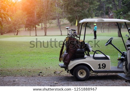Golfcar in beautiful golf course in the evening golf course with sunshine in thailand