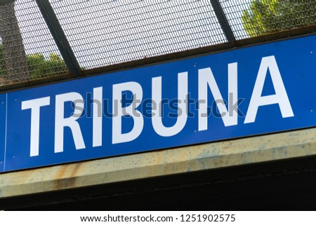 Italian text Tribuna (tribune) written on blue signage