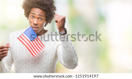 Afro american man flag of United States of America over isolated background annoyed and frustrated shouting with anger, crazy and yelling with raised hand, anger concept