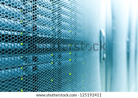 Abstract of modern high tech internet data center room with rows of racks with network and server hardware. Royalty-Free Stock Photo #125192411