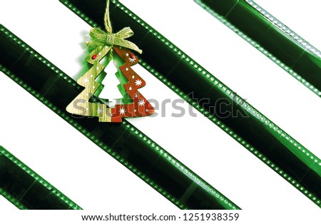 Old photographic film on a light background, strip. Christmas or New Year's decor. The concept of history, home archives, memorable dates. Selective focus, close-up.