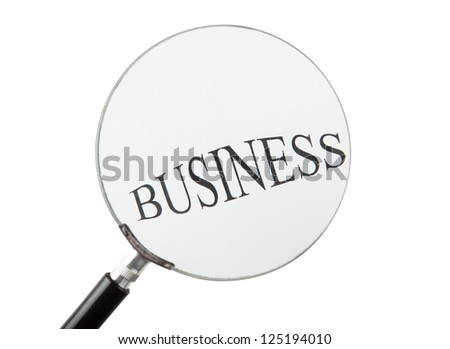 Word business written on paper and seen through a magnifying glass