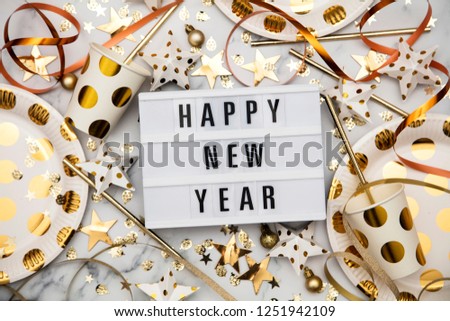 Happy new year lightbox celebration message with luxury gold party decorations