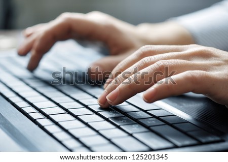 Close-up of typing female hands on keyboard Royalty-Free Stock Photo #125201345
