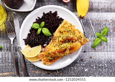 Traditional madeira dish - scabbardfish with bananas and passion fruit Royalty-Free Stock Photo #1252034551