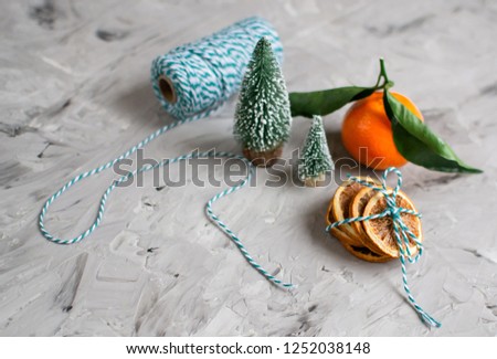 Mandarine with Leaves and Lights, Tangerine Orange on Gray Table Background Christmas New Year Decors Party Concept