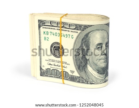 Pack of one hundred dollar bills folded in half and tied with a rubber band. A bundle isolated on a white background with clipping path.