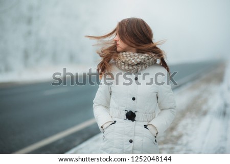 young beautiful model in the winter on the street