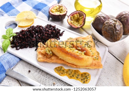 Traditional madeira dish - scabbardfish with bananas and passion fruit Royalty-Free Stock Photo #1252063057
