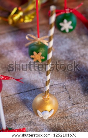 Various Christmas sweets and candies with christmas tree and wood background
