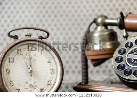 Vintage watch and telephone. Selective focus.