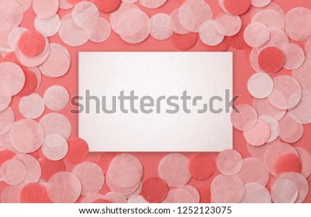Living coral color confetti on pastel pink background. Festive background  for your design.