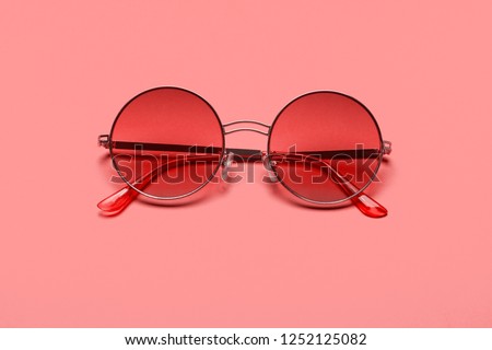 Trend photography on the theme of the new color of the year 2019 - Living Coral. Beautiful trendy sunglasses. Royalty-Free Stock Photo #1252125082