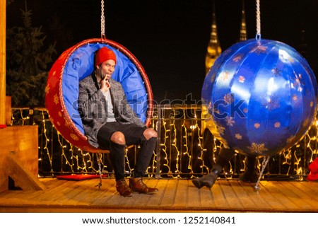 African american man posing for funny photo at Christmas market, Zagreb, Croatia.