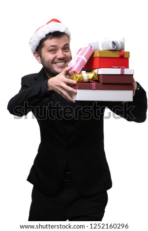 Picture of happy man in santa hat with boxes with gifts in hands