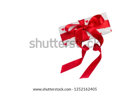 gift wrapped in a red box with a picture of a heart for Valentine's Day. Isolate on white background with shadow