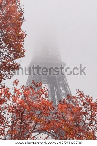 Eiffel Tower under heavy fog during an early morning in autumn