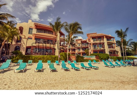 View of a hotel with the beach establishment on the Playa del Carmen beach in Mexico.