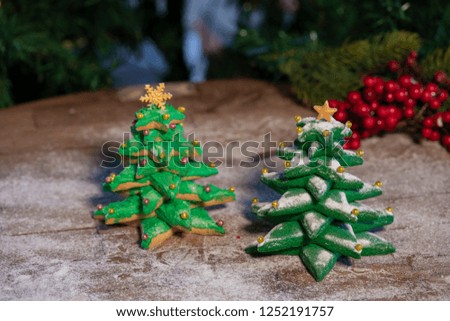 Various Christmas sweet cookies with christmas tree and wood background
