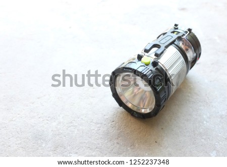 flashlight on on a gray concrete 
