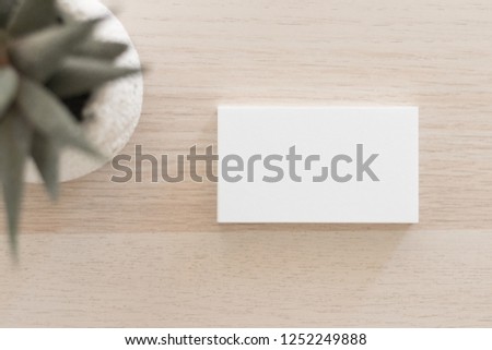 Horizontal stack of business cards on wood.
