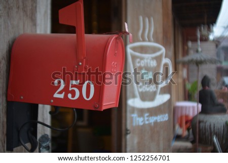 Post box on wooden fence