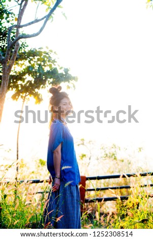 Asian female model poses for pictures in the outdoors