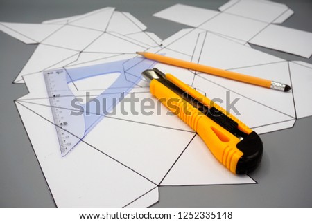 Design and engineering. Building and construction. Professional workplace with three dimensional figures unfolded ruler, pen and cutter .       Royalty-Free Stock Photo #1252335148