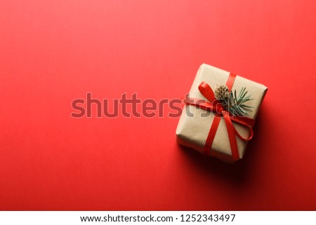 Christmas gift isolated on red background. Holiday mood. Top view with text space