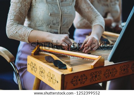 Girl plays Latvian national instrument kokle Royalty-Free Stock Photo #1252399552