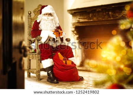 Red old Santa Claus in home interior 