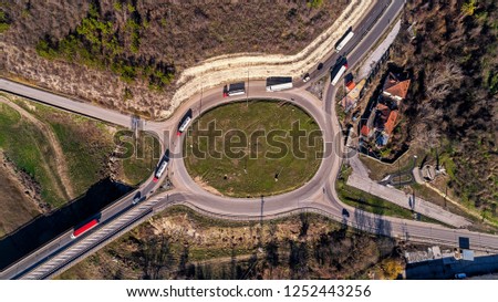Top view of the road with a circular motion and a flower bed. Aerial photography.
